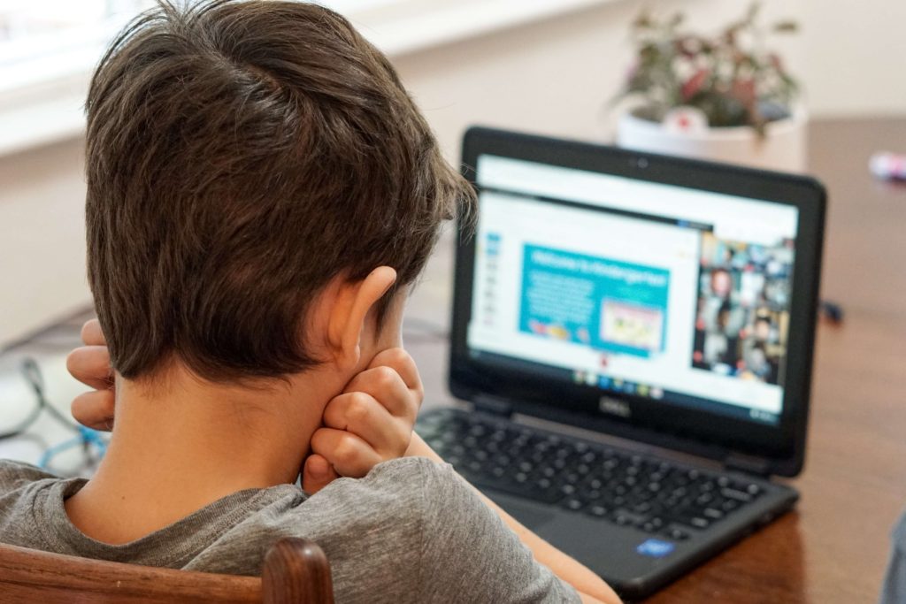 young boy working at laptop